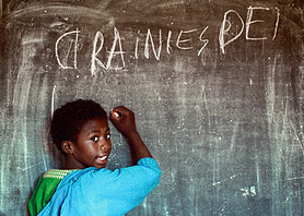 A child writing on the blackboard